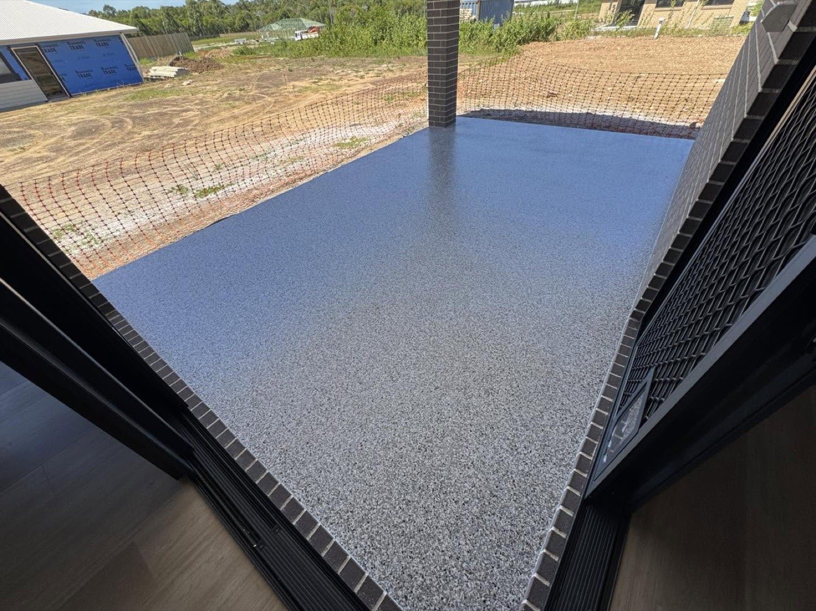 Grey flake epoxy coating on a covered patio slab